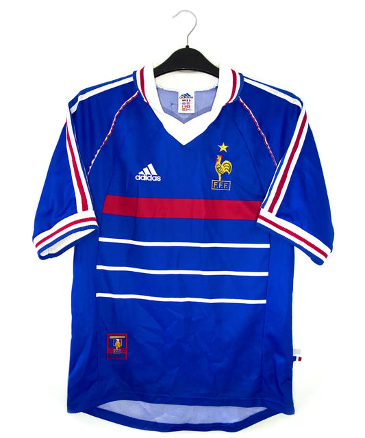 Maillot vintage bleu blanc rouge de l'équipe de france 1998. On peut retrouver l'équipementier adidas. Le maillot est floqué du numéro 10 Zinedine Zidane