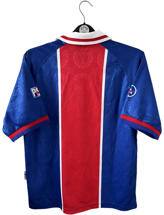 Maillot de foot vintage domicile bleu et rouge du PSG 1996/1997. On peut retrouver l'équipementier Nike et le sponsor OPEL. Il s'agit d'un maillot authentique d'époque.