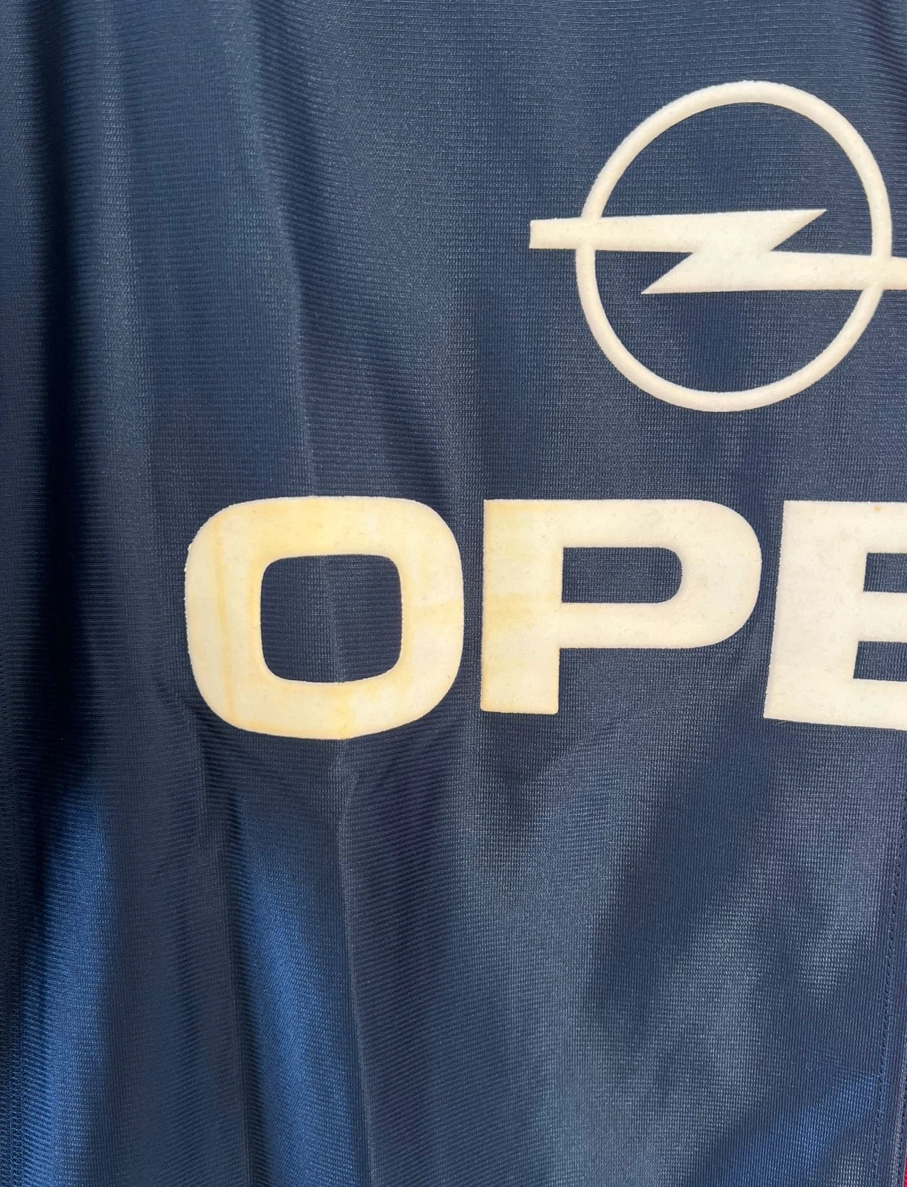 Maillot de foot vintage bleu et rouge du PSG 2001/2002. On peut retrouver l'équipementier Nike et le sponsor Opel. Il s'agit d'un maillot authentique d'époque.
