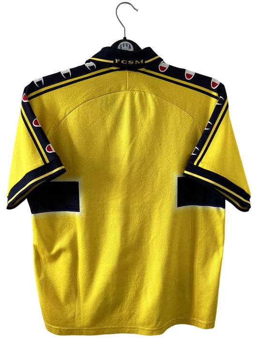 Maillot de foot vintage domicile jaune du FC Sochaux Montbéliard. On peut retrouver l'équipementier Champion et le sponsor Esso. Il s'agit d'un maillot authentique d'époque.