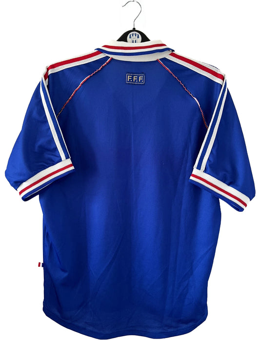 Maillot de foot vintage domicile bleu de l'Equipe de France 1998. On peut retrouver l'équipementier Adidas. Le maillot a été édité avant la finale puisqu'il ne comporte pas l'étoile. Le maillot possède également la signature et la mention "pour toi zinedine zidane". Il s'agit d'un maillot authentique d'époque.