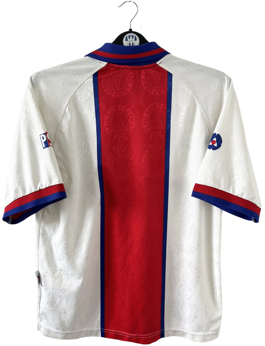 Maillot de foot vintage blanc rouge et bleu du PSG de la saison 1996/1997. On peut retrouver l'équipementier nike et le sponsor opel. Il s'agit d'un maillot authentique d'époque.