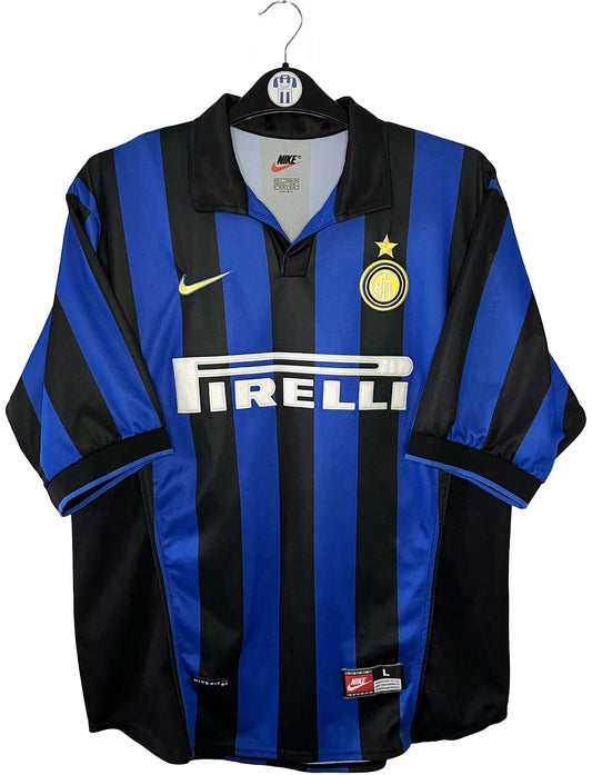 Maillot de foot vintage domicile bleu et noir de l'Inter Milan de la saison 1998/1999. On peut retrouver l'équipementier Nike et le sponsor Pirelli. Le maillot est floqué du numéro 9 Ronaldo. Il s'agit d'un maillot authentique d'époque.