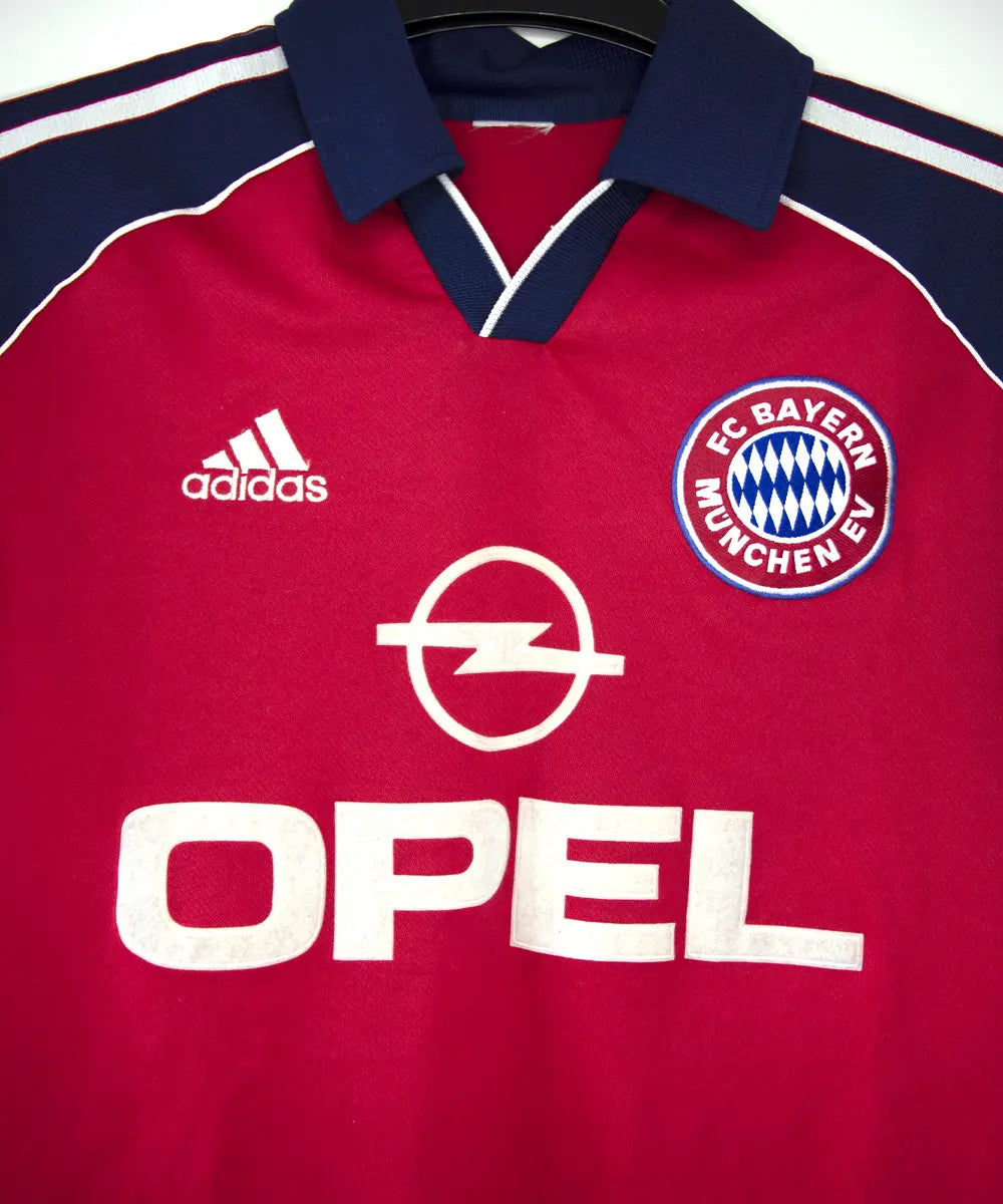 Maillot domicile rouge, bleu et blanc du bayern de la saison 1999-2001. On peut retrouver l'équipementier adidas et le sponsor opel