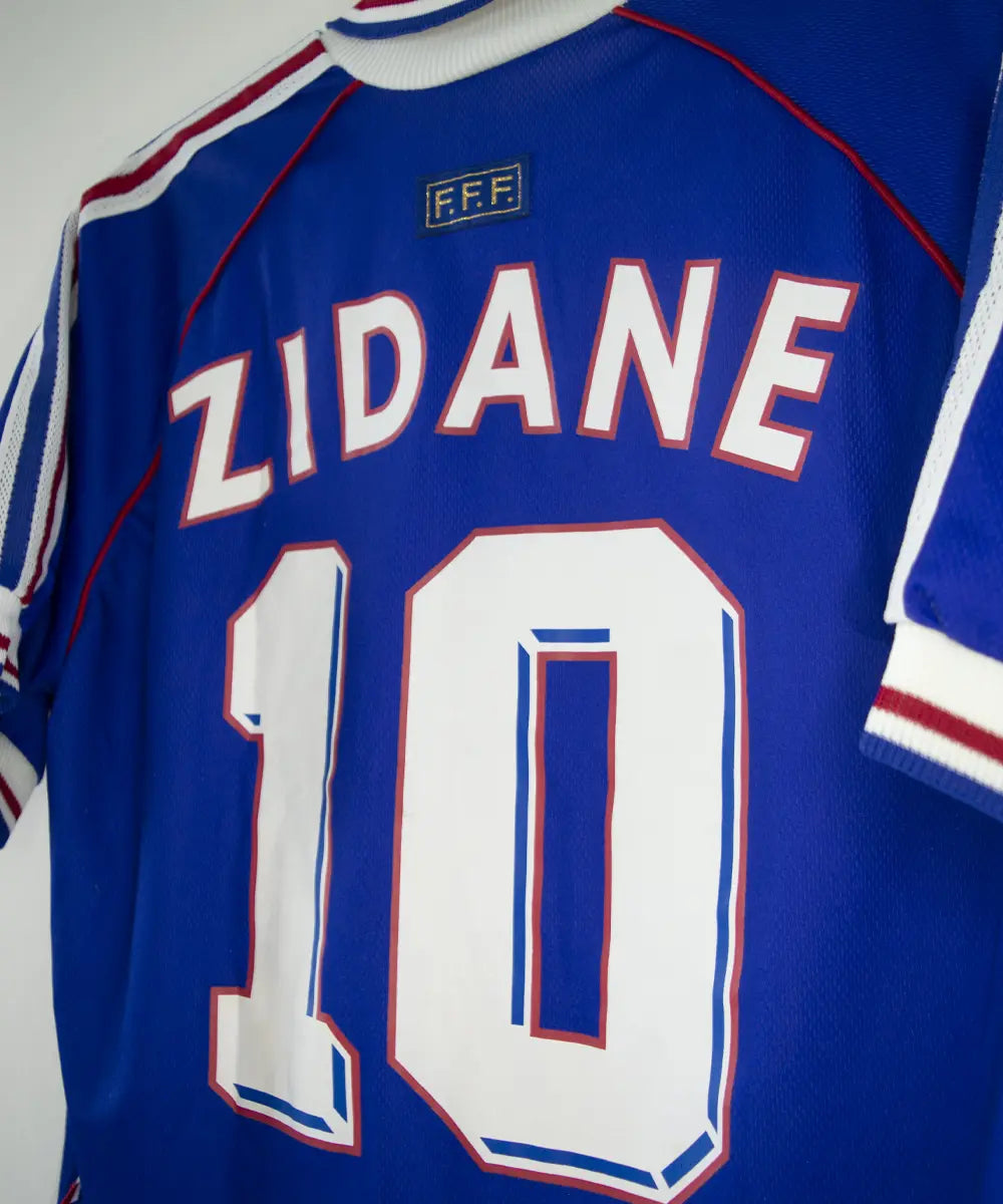 Maillot équipe de france 1998 domicile de couleur bleu, blanc et rouge. On peut retrouver l'équipementier adidas. Le maillot est floqué du numéro 10 Zidane