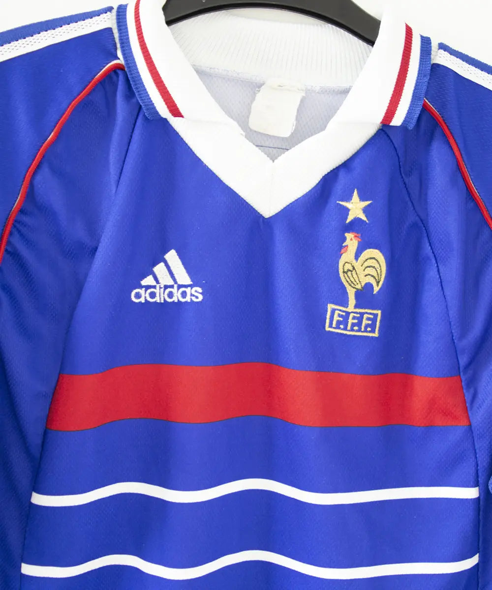 Maillot domicile bleu adidas de l'équipe de france 1998. Le maillot est floqué du numéro 10 Zinedine Zidane. Sur cette photo on peut voir le devant du maillot de près