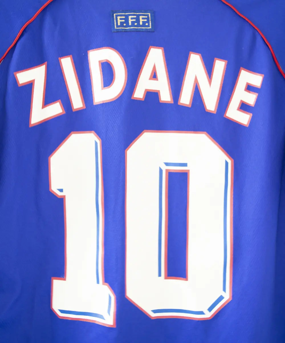 Maillot domicile bleu adidas de l'équipe de france 1998. Le maillot est floqué du numéro 10 Zinedine Zidane. Sur cette photo on peut voir le flocage de près