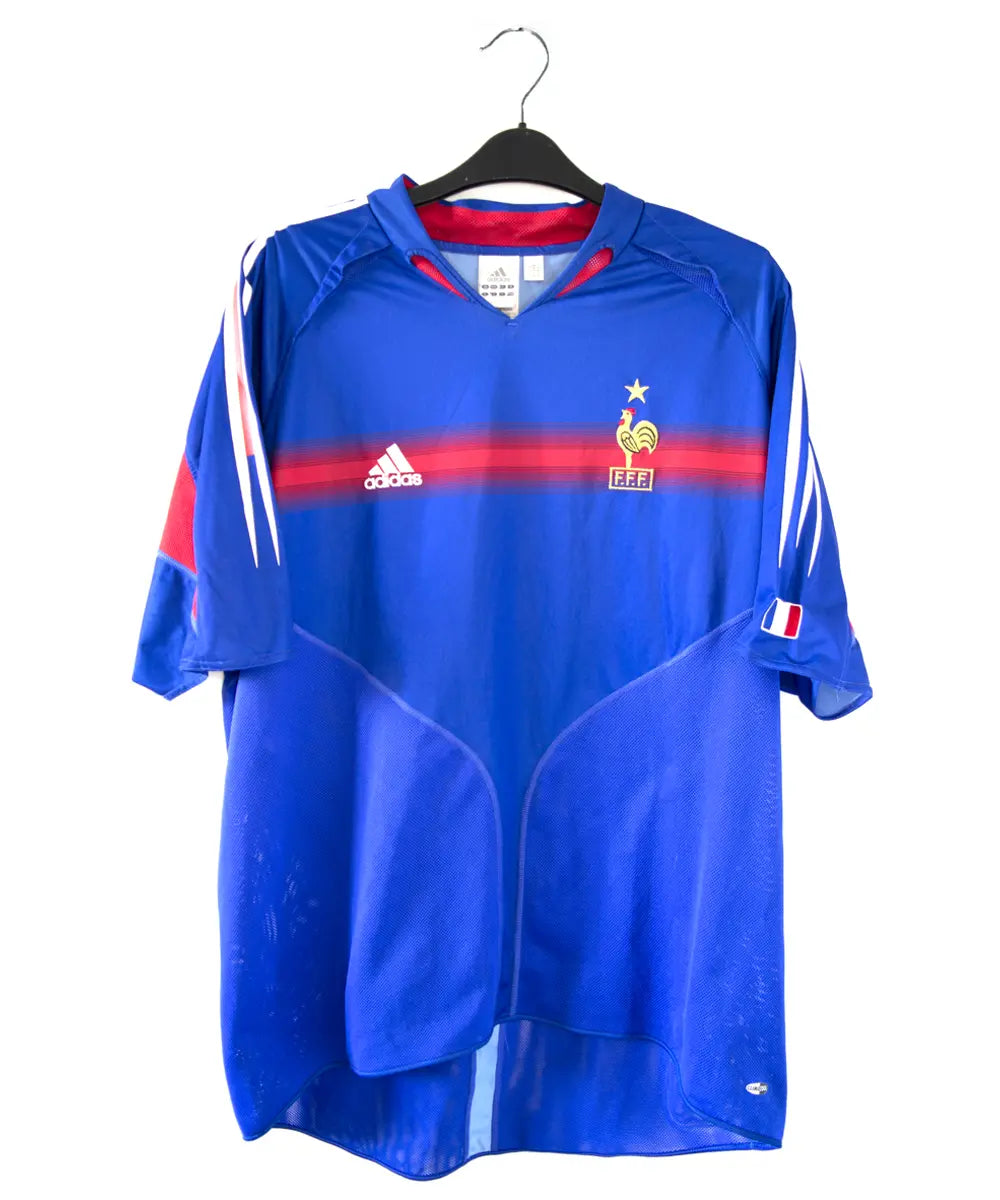 Maillot bleu blanc et rouge de l'équipe de france 2004. On peut retrouver l'équipementier adidas