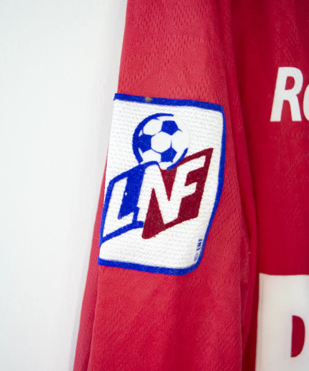 Maillot domicile du stade rennais porté lors de la saison 2000-2001 par Echouafni. Le maillot est de couleur rouge et noir. On peut retrouver l'équipementier asics et les sponsor Pinault et Finaref.