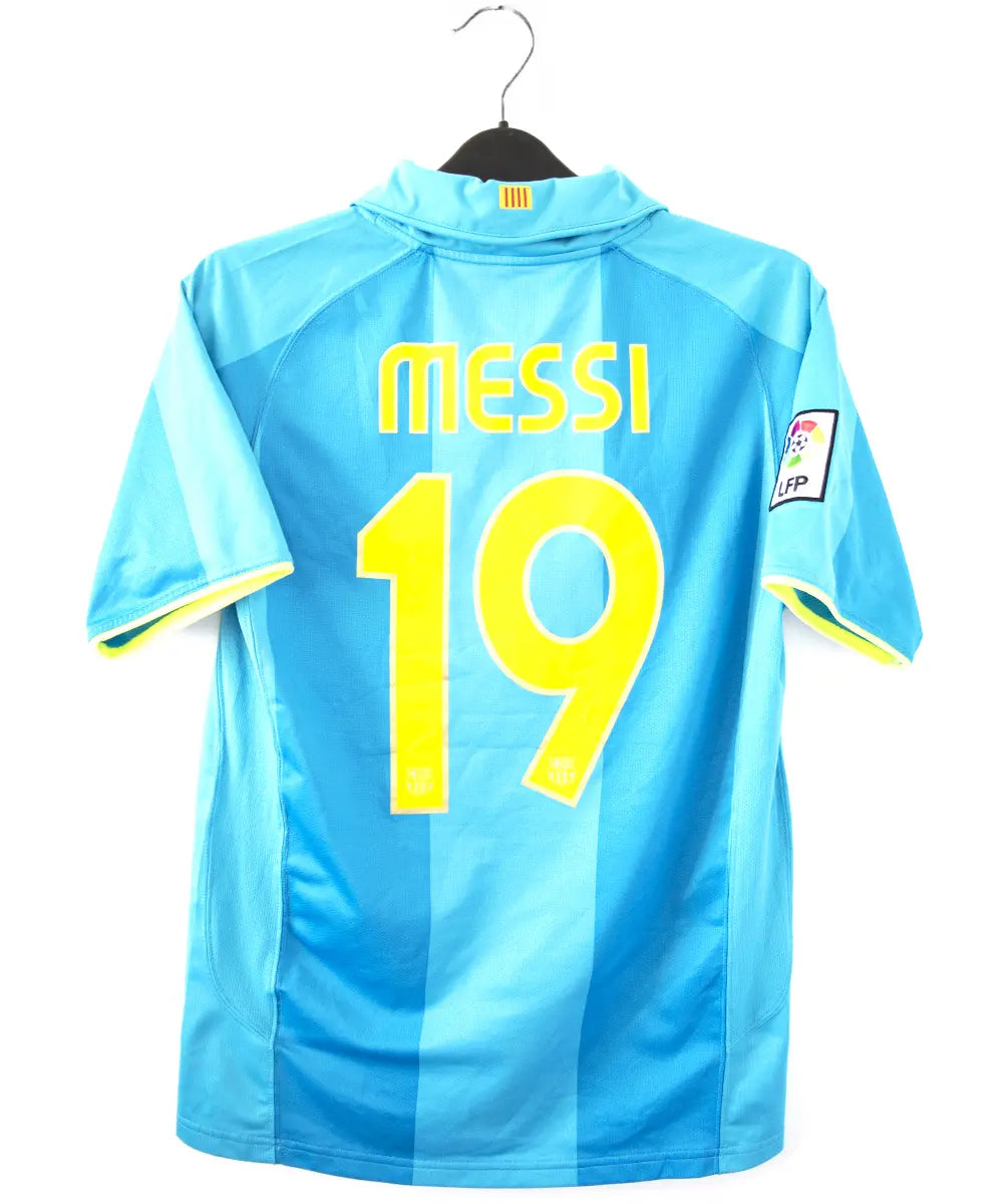 Maillot extérieur vintage bleu et jaune du FC Barcelone de la saison 2007-2009. On peut retrouver le sponsor unicef et l'équipementier nike. Le maillot est floqué du numéro 19 Messi