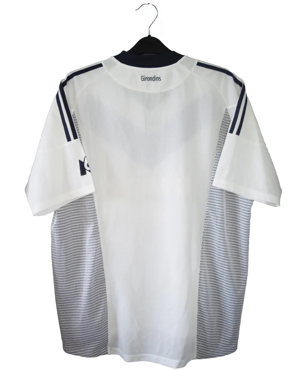 Maillot extérieur des girondins de bordeaux de couleur blanc et bleu. On peut retrouver l'équipementier adidas et le sponsor siemens mobile et M6. L'étiquette du maillot comporte les numéros AKU001