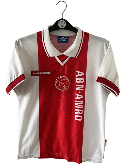 Maillot de foot vintage domicile rouge et blanc de l'Ajax Amsterdam de la saison 1998/1999. On peut retrouver l'équipementier Umbro et le sponsor ABN AMRO. Il s'agit d'un maillot authentique d'époque.