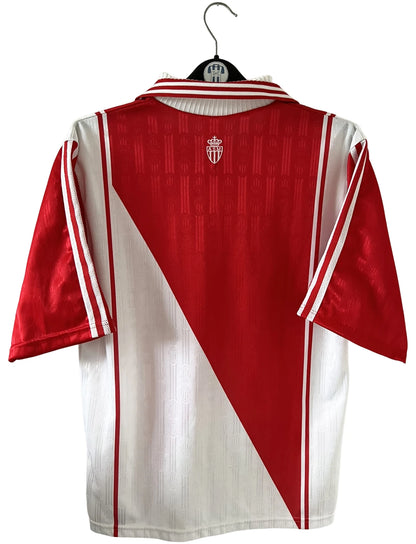 Maillot de foot vintage domicile rouge et blanc de l'as monaco saison 1997/1998. On peut retrouver l'équipementier Adidas et le sponsor Continental Edison. Il s'agit d'un maillot authentique d'époque.