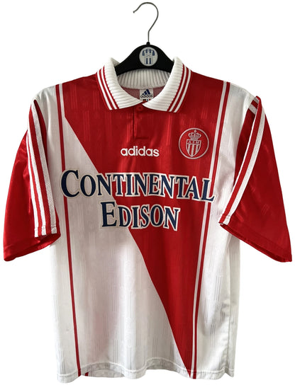 Maillot de foot vintage domicile rouge et blanc de l'AS Monaco 1997/1998. n peut retrouver l'équipementier Adidas et le sponsor Continental Edison. Il s'agit d'un maillot authentique d'époque.