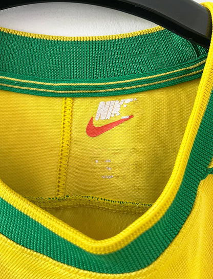Maillot de foot vintage domicile jaune du Brésil 1998. On peut retrouver l'équipementier Nike. Le maillot est floqué du numéro 9 Ronaldo. Il s'agit d'un maillot authentique d'époque.