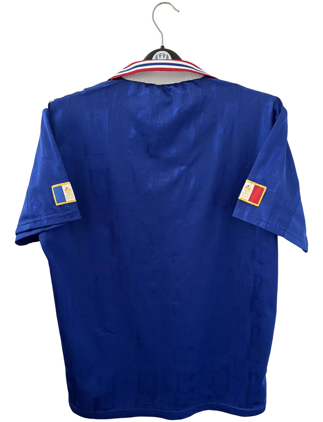 Maillot de foot vintage domicile bleu de l'équipe de france 1996. On peut retrouver l'équipementier Adidas. Il s'agit d'un maillot authentique d'époque.