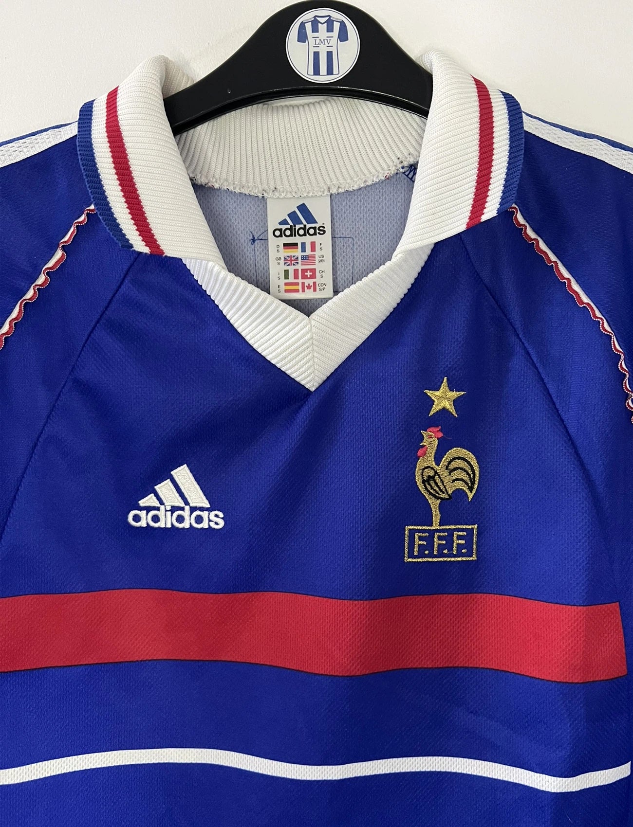 Maillot de foot vintage domicile bleu de l'équipe de france 1998. On peut retrouver l'équipementier Adidas. Le maillot est floqué du numéro 10 Zinedine Zidane. Il s'agit d'un maillot authentique d'époque.
