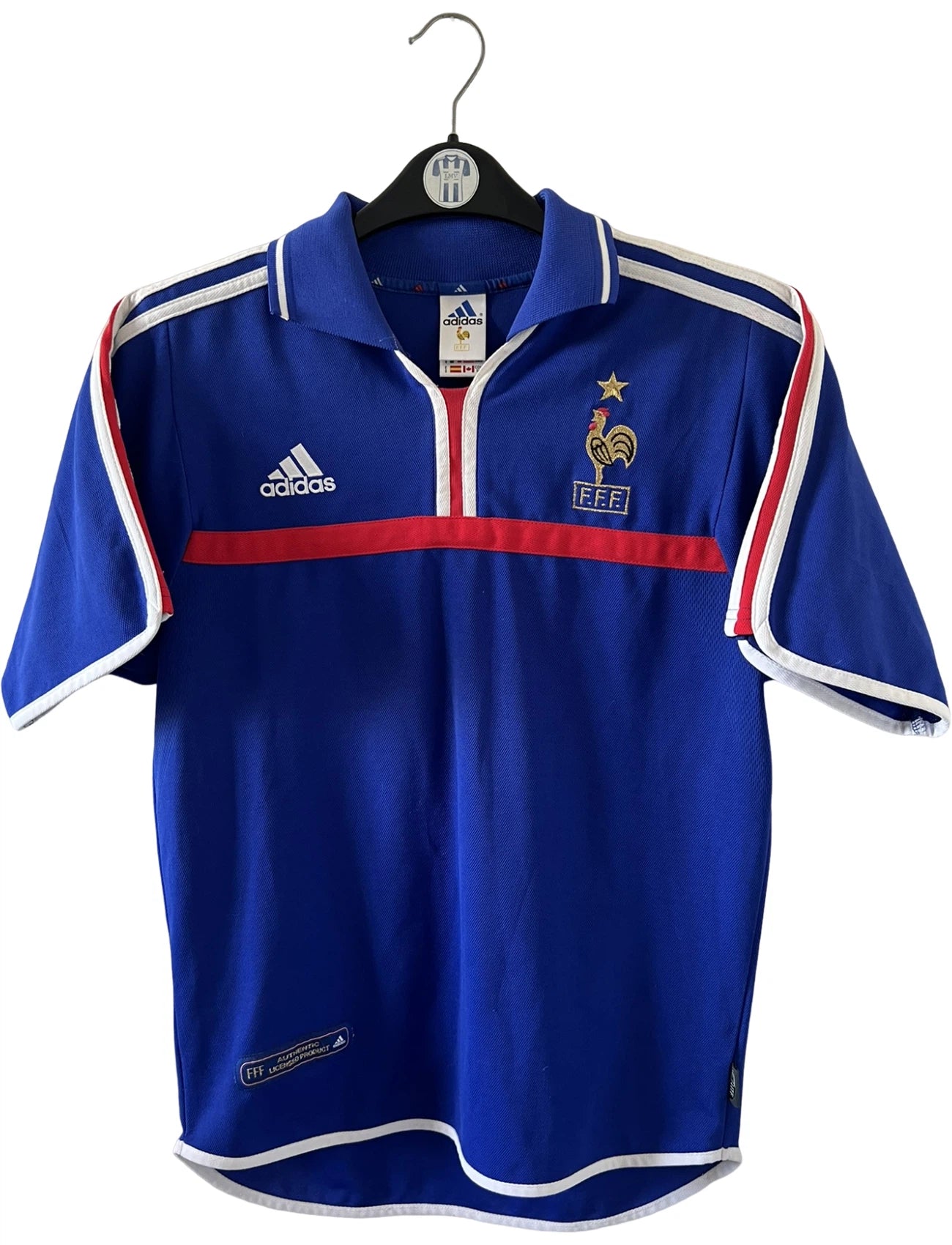 Maillot de foot vintage domicile bleu de l'Equipe de France 2000. On peut retrouver l'équipementier Adidas. Le maillot est floqué du numéro 10 Zinedine Zidane. Il s'agit d'un maillot authentique d'époque.