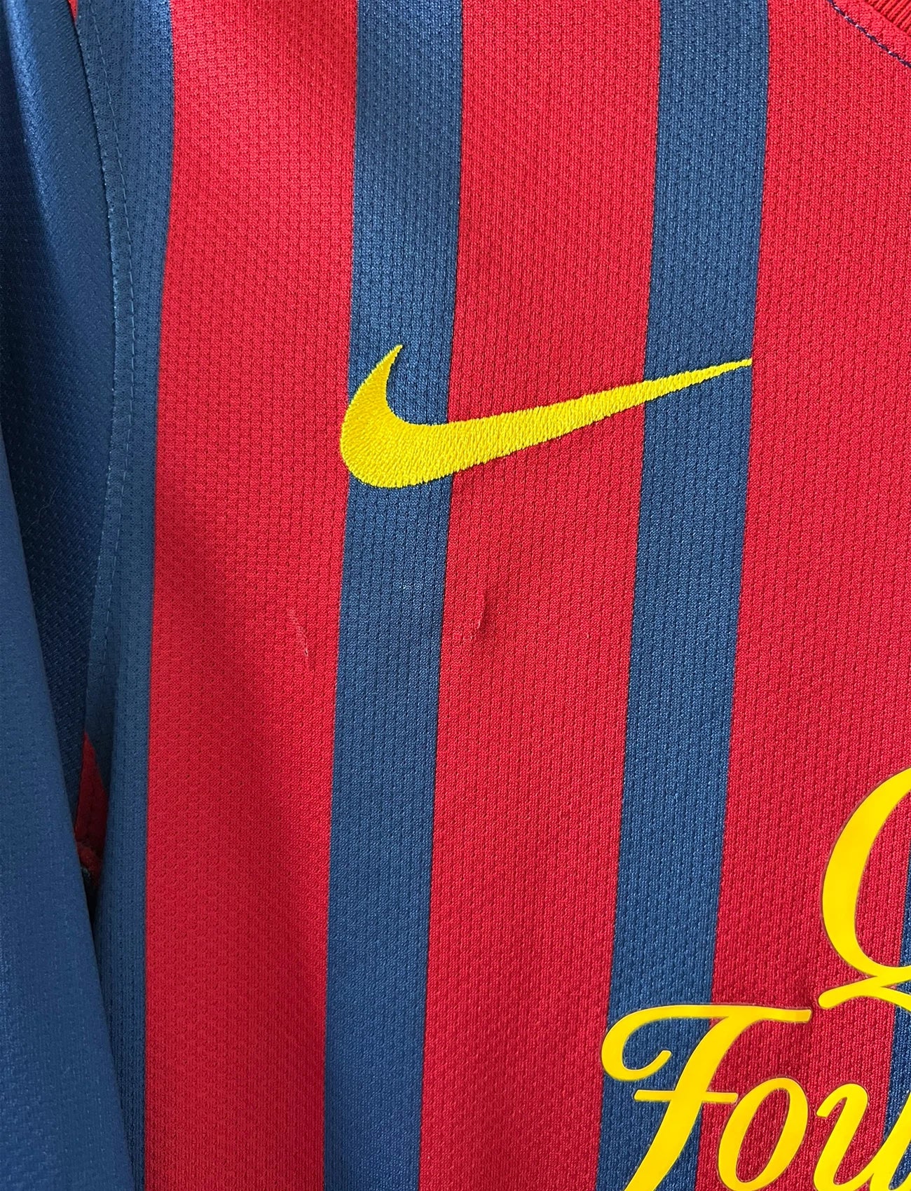 Maillot de foot vintage domicile rouge et bleu du FC Barcelone 2011/2012. On peut retrouver l'équipementier Nike et le sponsor Qatar Foundation. Le maillot est floqué du numéro 10 Lionel Messi. Il s'agit d'un maillot authentique d'époque