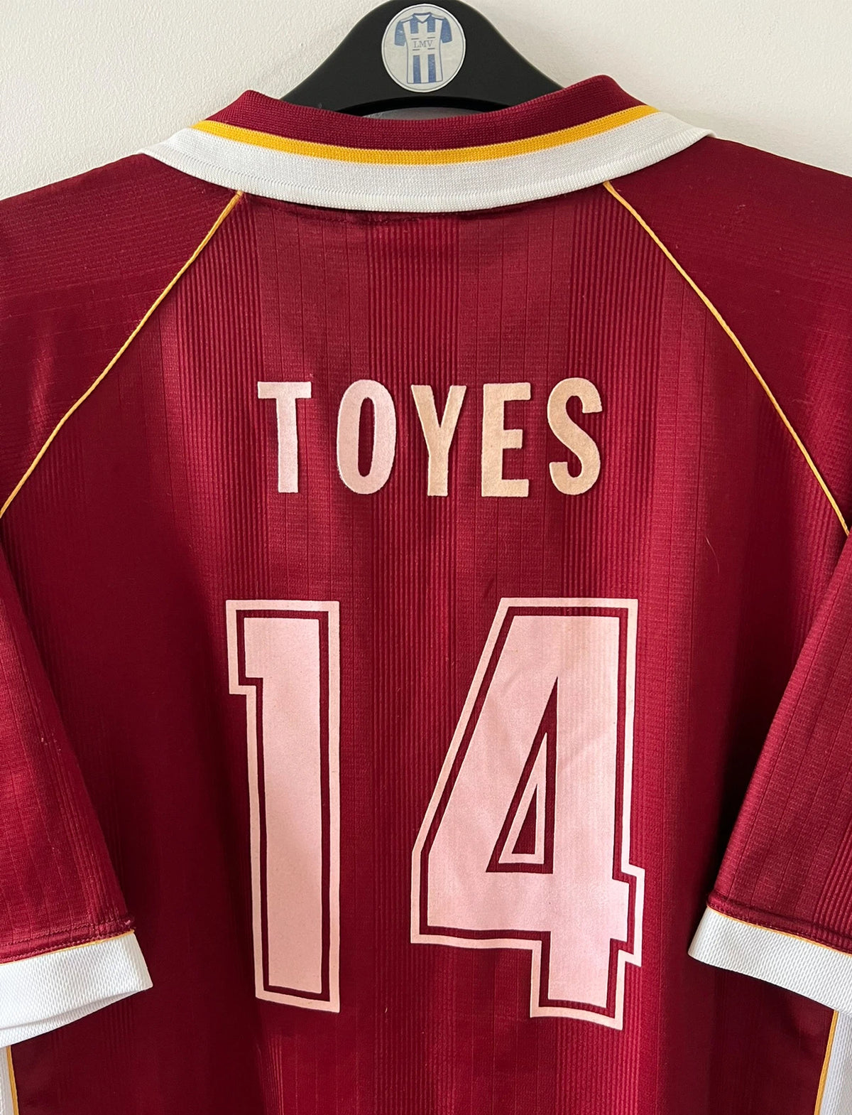 Maillot de foot vintage domicile rouge et blanc du FC Metz de la saison 1998/1999. On peut retrouver l'équipementier Puma et le sponsor Sollac. Le maillot est floqué du numéro 14 Geoffray Toyes. Il s'agit d'un maillot authentique d'époque.