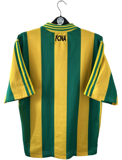 Maillot de foot vintage domicile jaune et vert du FC Nantes 1996/1997. On peut retrouver l'équipementier Adidas et le sponsor Eurest. Il s'agit d'un maillot authentique d'époque.