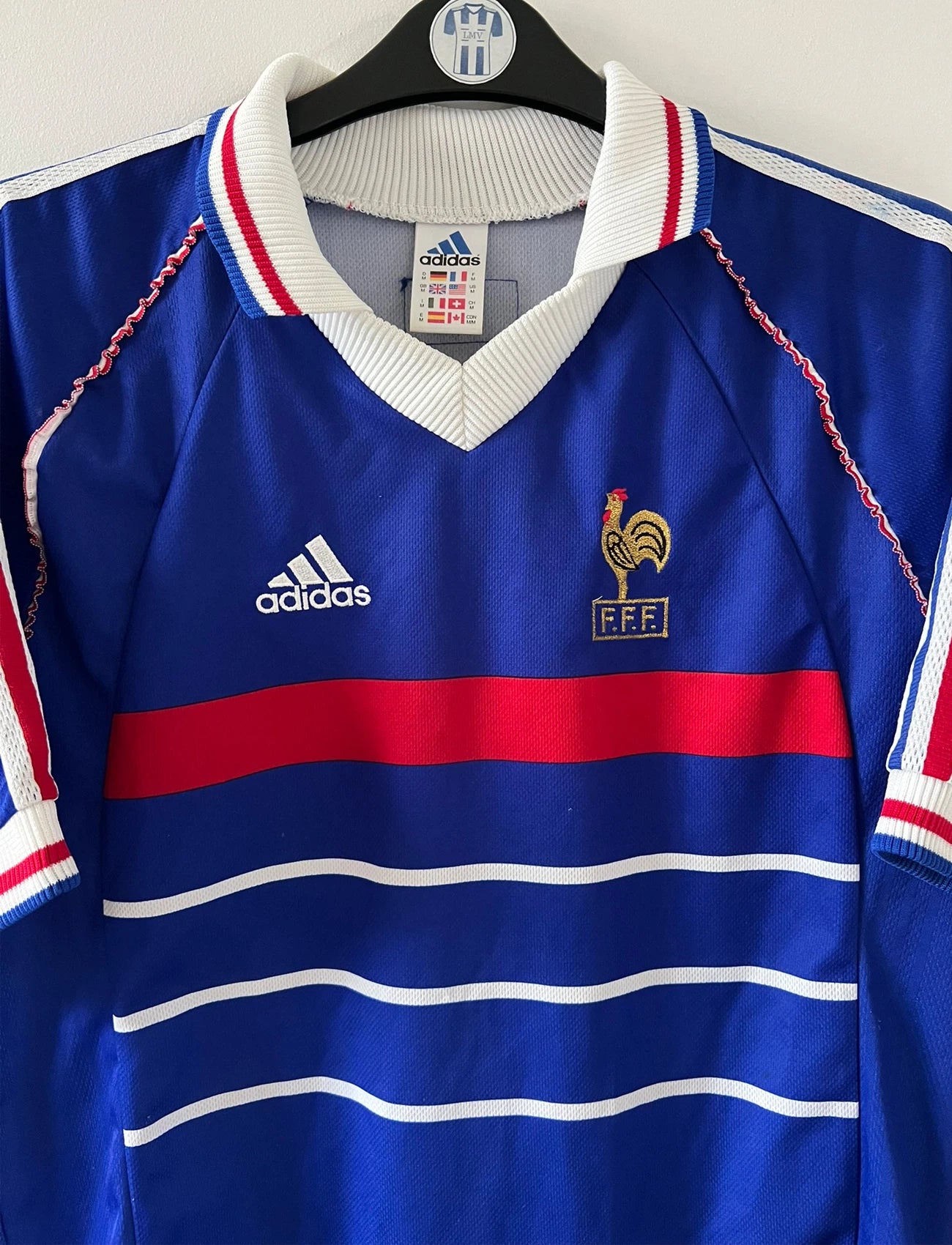 Maillot de foot vintage domicile bleu blanc et rouge de l'équipe de france 1998. On peut retrouver l'équipementier Adidas. Il s'agit d'un maillot authentique d'époque.