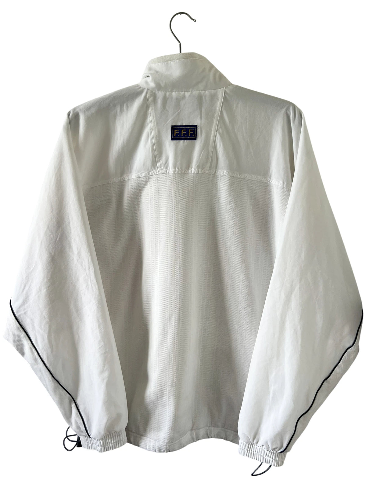 Veste de foot vintage blanche de l'Equipe de France 1998. On peut retrouver l'équipementier Adidas. Il s'agit d'un maillot authentique d'époque.