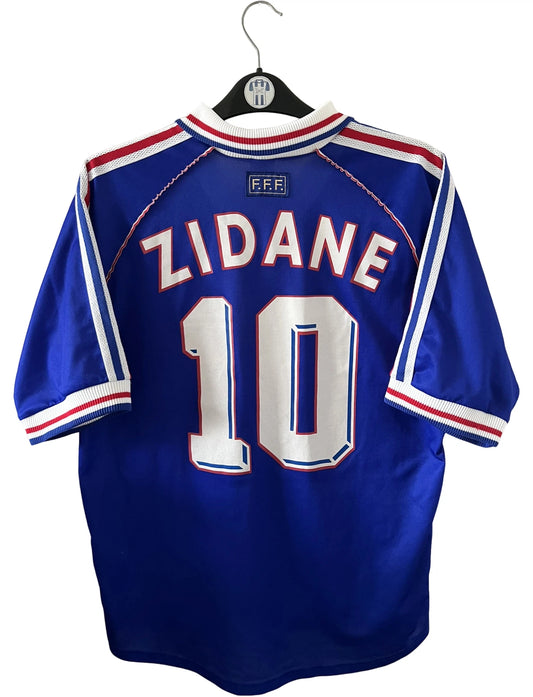 Maillot foot vintage domicile equipe de france 1998 bleu blanc et rouge. On peut retrouver l'équipementier adidas. Ils 'agit d'un maillot authentique d'époque floqué Zinedine Zidane