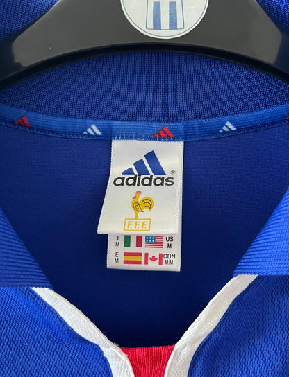 Maillot de foot vintage domicile Equipe de France 2000. On peut retrouver l'équipementier Adidas. Il s'agit d'un maillot authentique d'époque.