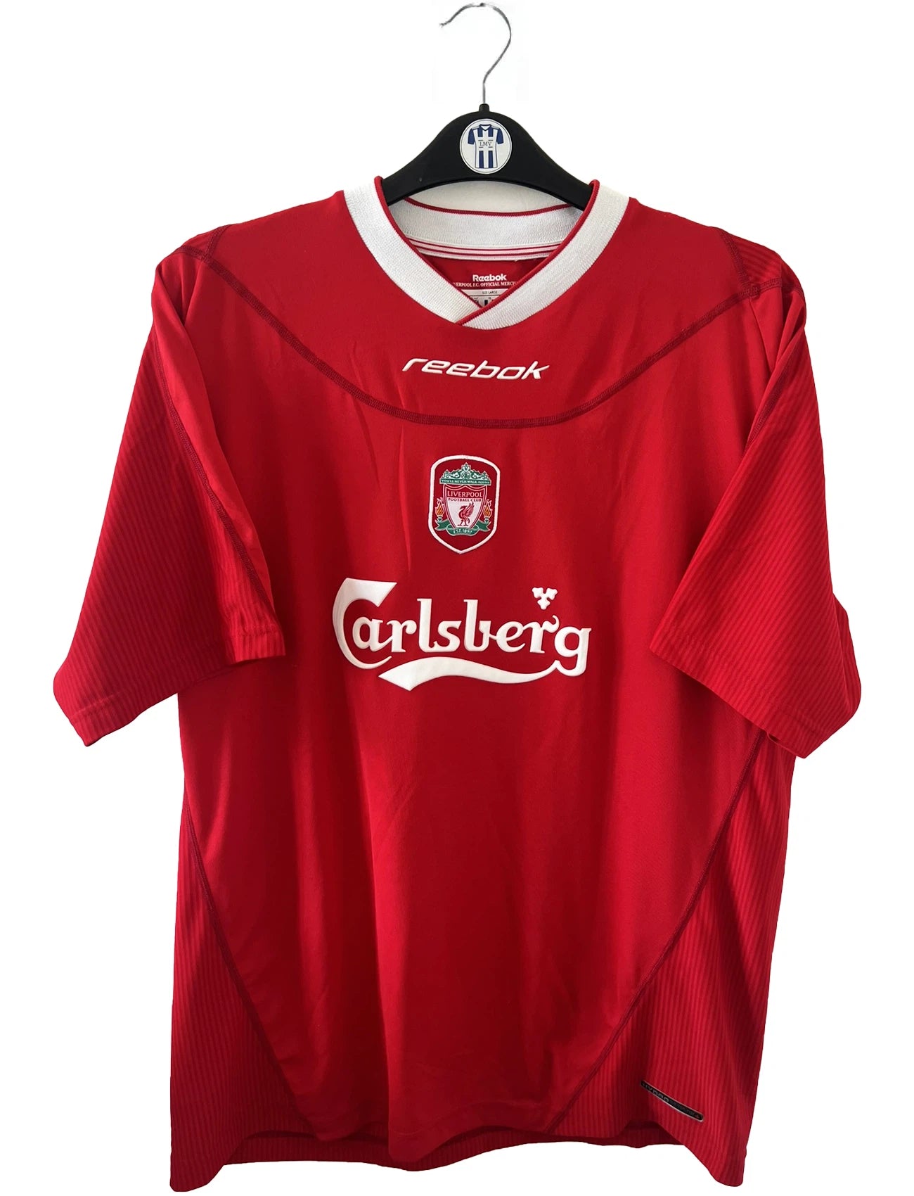Maillot de foot vintage domicile rouge de liverpool de la saison 2002/2004. On peut retrouver l'équipementier Reebok. Il s'agit d'un maillot authentique d'époque
