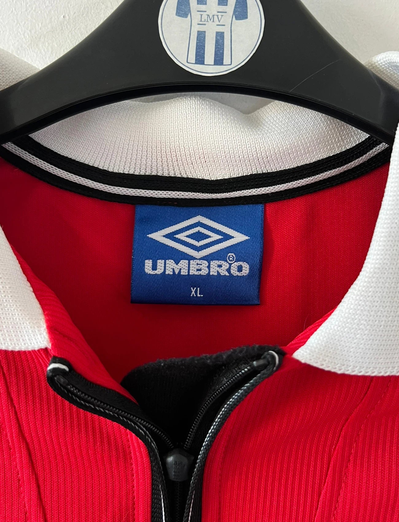 Maillot de foot vintage domicile rouge de Manchester United saison 1998/2000. On peut retrouver l'équipementier Umbro et le sponsor Sharp. Il s'agit d'un maillot authentique d'époque.