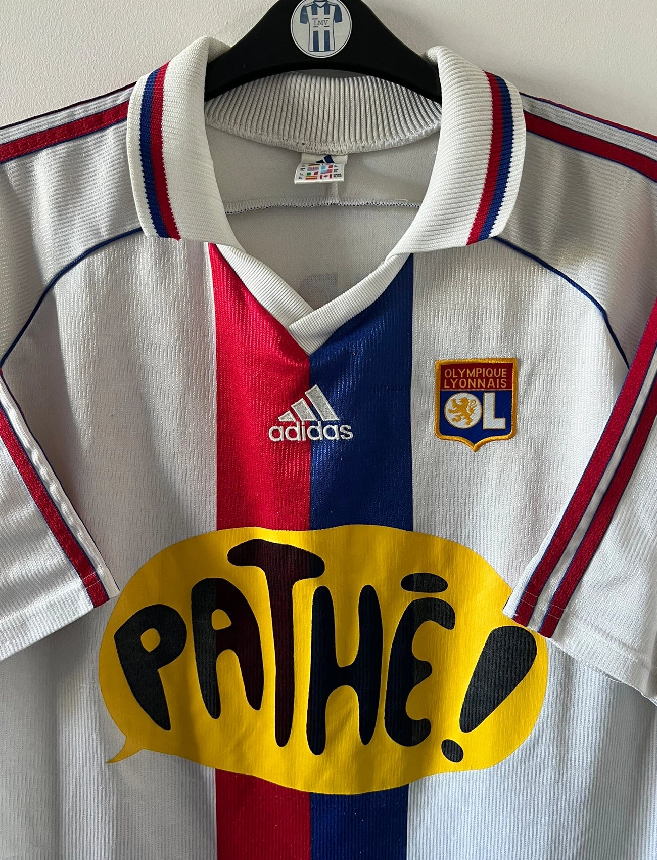 Maillot de foot vintage domicile blanc de l'OL 1999/2000. On peut retrouver l'équipementier Adidas et le sponsor Pathé. Le maillot est floqué du numéro 9 Sonny Anderson. Il s'agit d'un maillot authentique d'époque