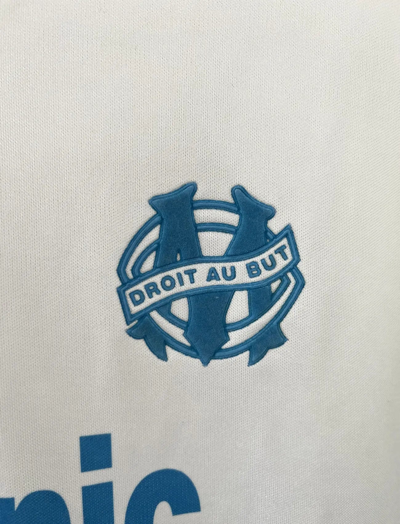 Maillot foot vintage domicile blanc et bleu de l'om de la saison 1991-1992. On peut retrouver l'équipementier adidas et le sponsor Panasonic. Il s'agit d'un maillot authentique d'époque.