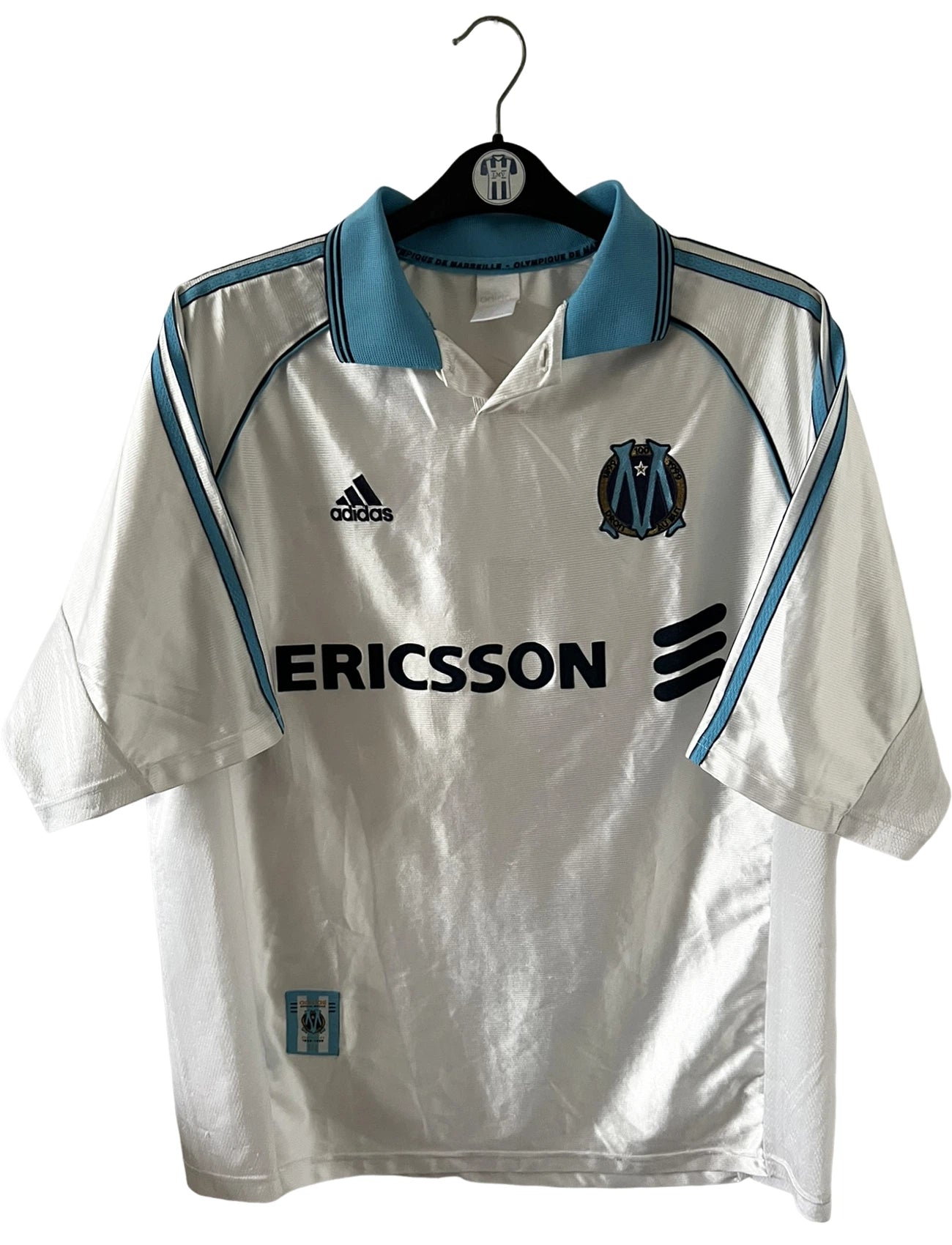 Maillot de foot vintage domicile blanc de l'OM 1998/1999. On peut retrouver l'équipementier Adidas et le sponsor Ericsson. Il s'agit d'un maillot authentique d'époque.