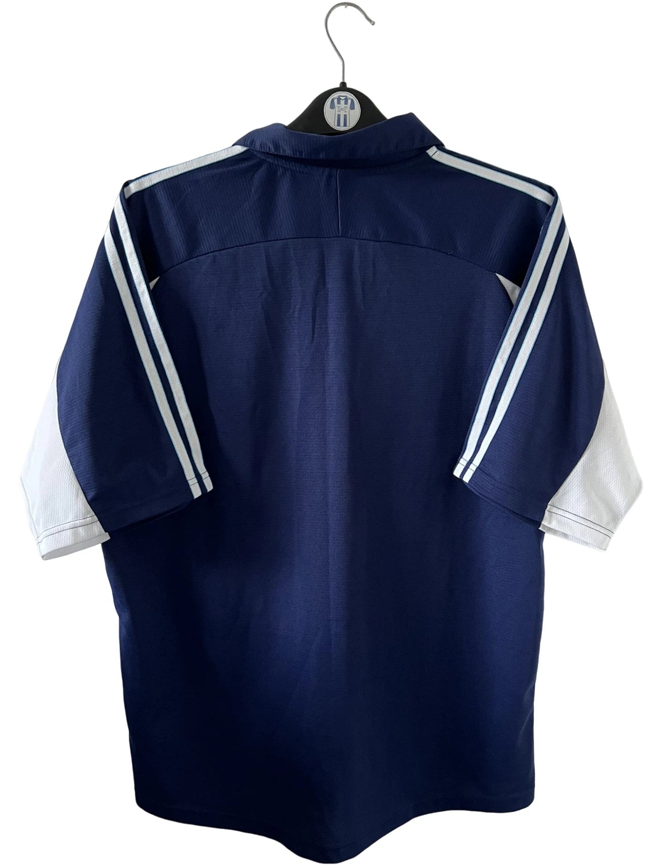 Maillot de foot vintage OM 1999/2000 extérieur bleu. On peut retrouver l'équipementier Adidas et le sponsor Ericsson. Il s'agit d'un maillot authentique d'époque.