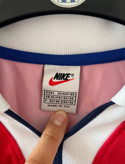 Maillot de foot vintage domicile PSG 1997/1998. On peut retrouver l'équipementier Nike et le sponsor Opel. Le maillot est floqué du numéro 18 Florian Maurice. Il s'agit d'un maillot authentique d'époque.