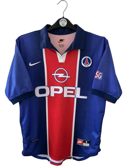Maillot de foot vintage domicile rouge et bleu du PSG 1998/1999. On peut retrouver l'équipementier Nike et le sponsor OPEL. Il s'agit d'un maillot authentique d'époque.