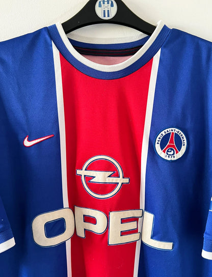 Maillot de foot vintage domicile du PSG 1999/2000. On peut retrouver l'équipementier Nike et le sponsor Opel. Il s'agit d'un maillot authentique d'époque.