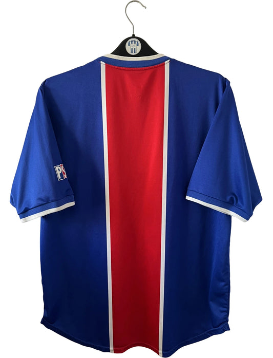 Maillot de foot vintage domicile bleu et rouge du PSG 1999/2000. On peut retrouver l'équipementier Nike et le sponsor Opel. Il s'agit d'un maillot authentique d'époque.