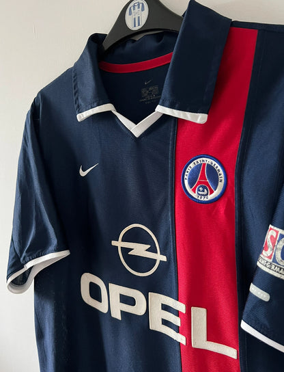 Maillot de foot vintage domicile bleu du PSG de la saison 2001/2002. On peut retrouver l'équipementier Nike et le sponsor Opel. Il s'agit d'un maillot authentique d'époque.