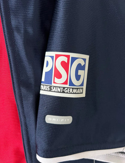 Maillot de foot vintage domicile bleu du PSG de la saison 2001/2002. On peut retrouver l'équipementier Nike et le sponsor Opel. Il s'agit d'un maillot authentique d'époque.