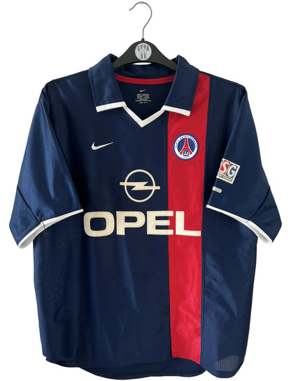 Maillot de foot vintage domicile bleu du PSG 2001/2002. On peut retrouver l'équipementier Nike et le sponsor Opel. Il s'agit d'un maillot authentique d'époque.