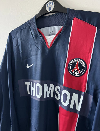 Maillot de foot vintage domicile bleu et rouge issu du stock pro du PSG. Il s'agit du maillot de la saison 2003/2004. On peut retrouver l'équipementier Nike et le sponsor Thomson. Il s'agit d'un maillot authentique d'époque.