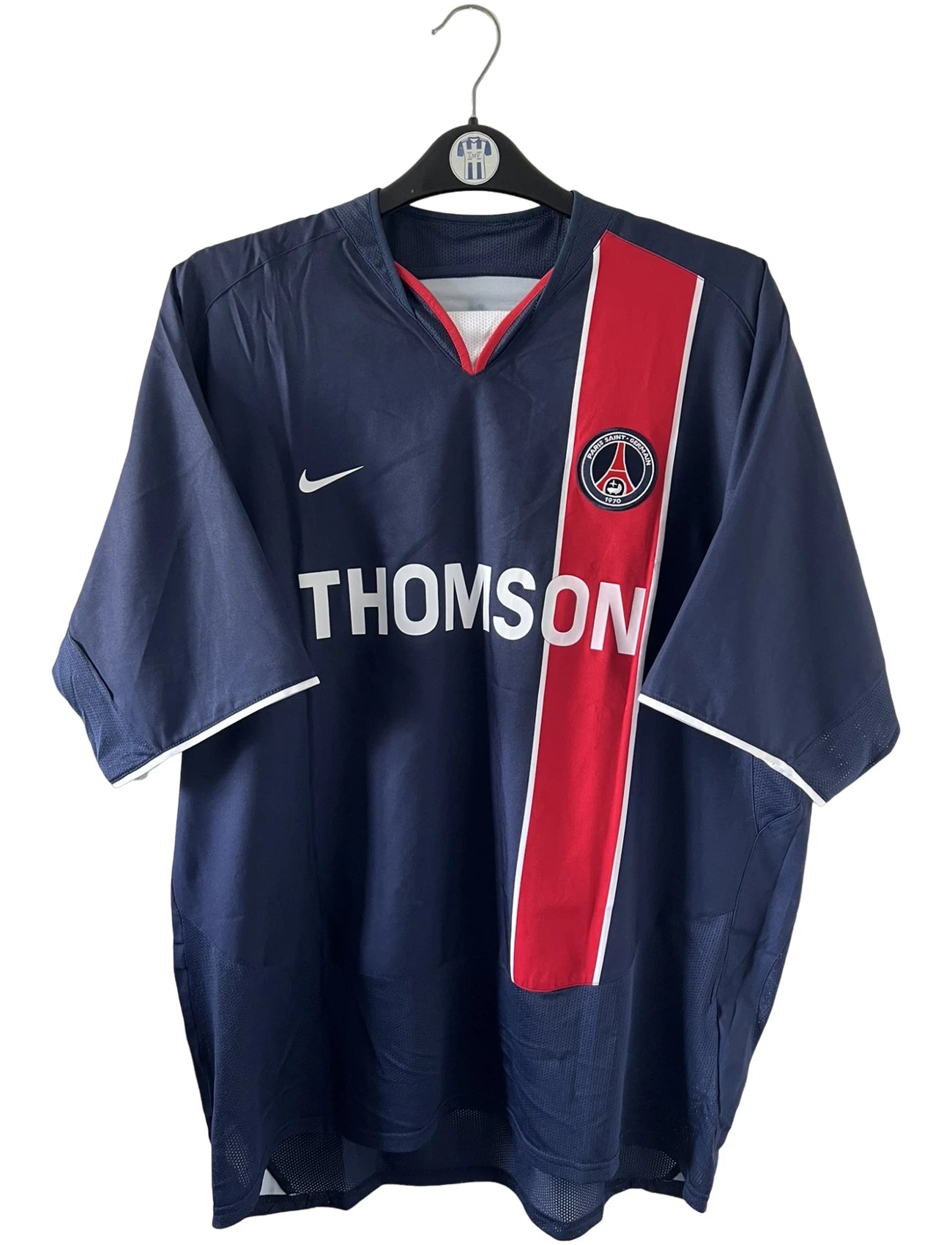 Maillot de foot vintage domicile rouge et bleu du PSG de la saison 2003/2004. On peut retrouver l'équipementier Nike et le sponsor Thomson. Il s'agit d'un maillot authentique d'époque.