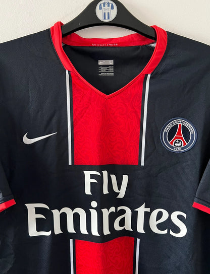 Maillot de foot vintage domicile bleu et rouge du PSG 2007/2008. On peut retrouver l'équipementier Nike et le sponsor Fly Emirates. Il s'agit d'un maillot authentique d'époque.