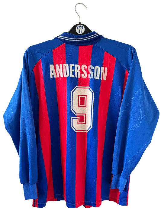 Maillot de foot vintage domicile rouge et bleu du SM Caen de la saison 1994/1995. On peut retrouver l'équipementier Puma et le sponsor Continent. Le maillot est floqué du numéro 9 Kennet Andersson. Il s'agit d'un maillot authentique d'époque.