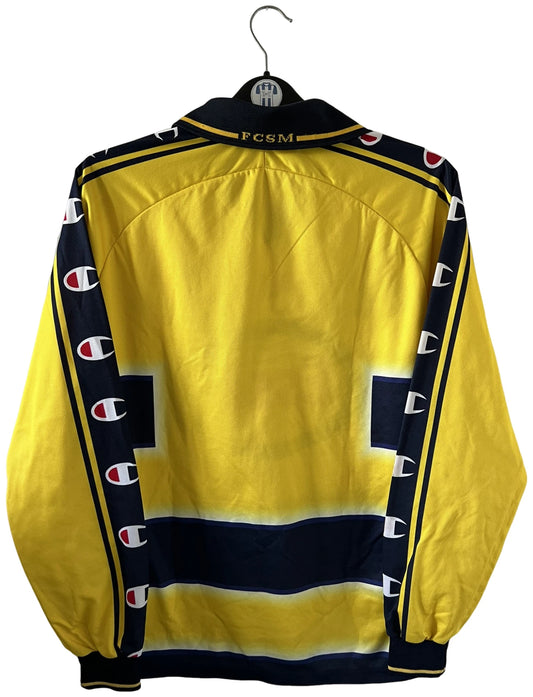Maillot de foot vintage domicile jaune du FC Sochaux-Montbliard, de la saison 2002/2004. On peut retrouver l'équipementier Champion et le sponsor Esso. Il s'agit d'un maillot authentique d'époque.