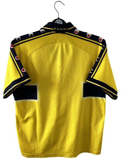 Maillot de foot vintage domicile jaune du FC Sochaux Montbéliard. On peut retrouver l'équipementier Champion et le sponsor Esso. Il s'agit d'un maillot authentique d'époque.