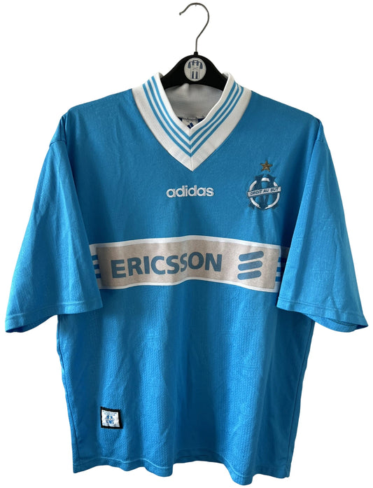 Maillot de foot vintage bleu extérieur de l'OM 1997/1998. On peut retrouver l'équipementier Adidas et le sponsor Ericsson. Il s'agit d'un maillot authentique d'époque.