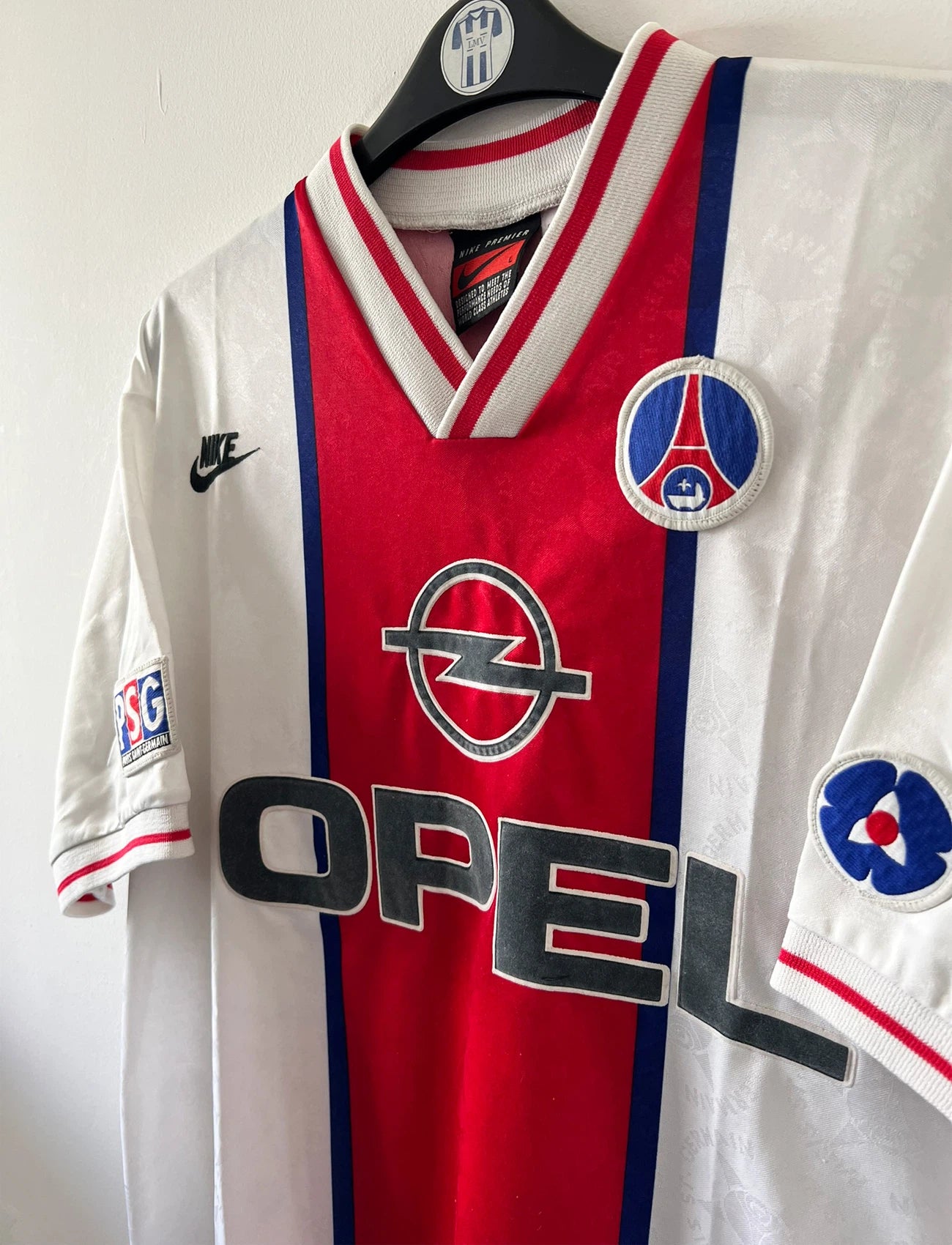 Maillot de foot vintage extérieur blanc du PSG 1995/1996. On peut retrouver la bande hechter avec l'équipementier Nike et le sponsor Opel. Il s'agit d'un maillot authentique d'époque.